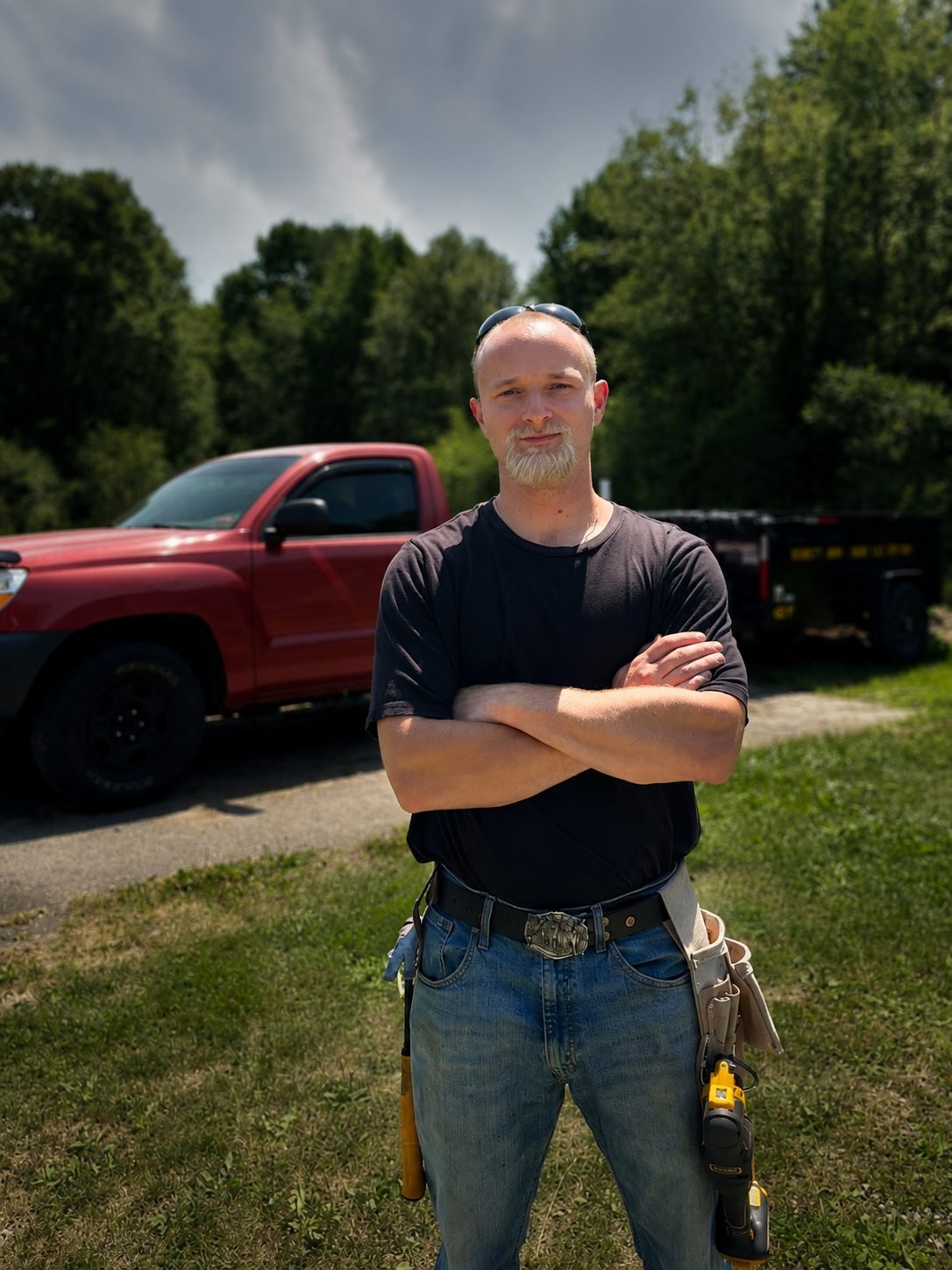 Julius Bennett, owner of Bennett Junk & Demo LLC, standing in front of his truck and trailer