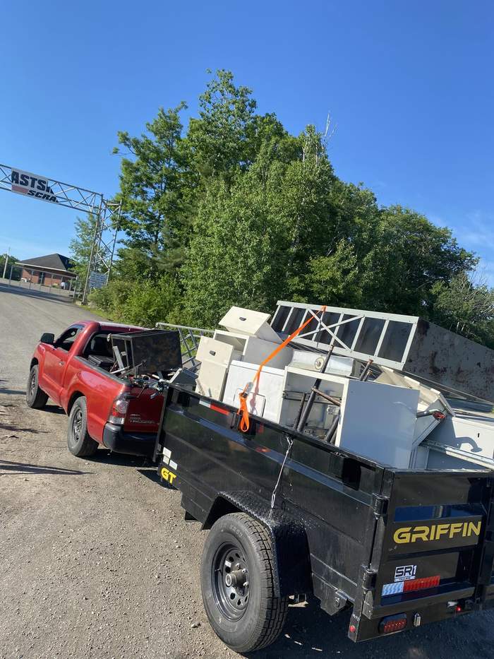 Truck and trailer loaded with junk and scrap for removal